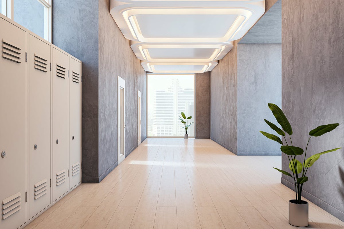 Spacious modern hallway with lockers and creative ceiling lights in a tall building interior